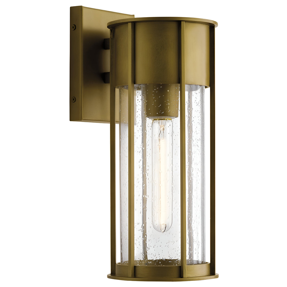 The Camillo Outdoor 1 Light Medium Wall Lantern in Natural Brass is a sleek, modern outdoor lighting fixture featuring a cylindrical design. Its natural brass finish pairs beautifully with clear seeded glass panels, highlighting the visible elongated bulb and adding an elegant touch to any exterior space.