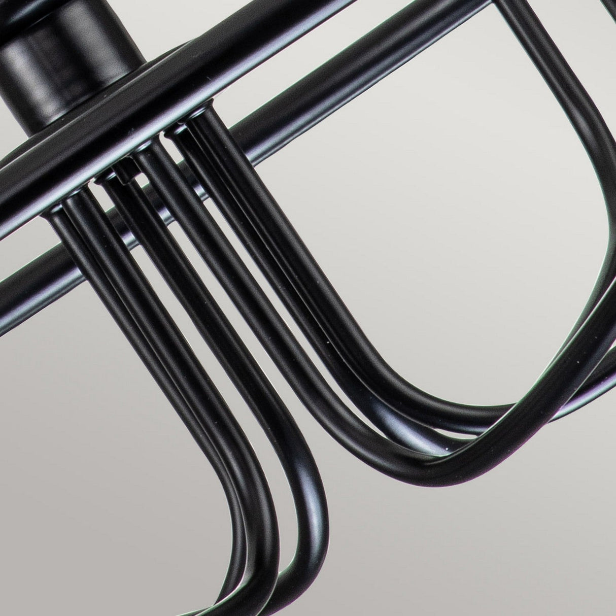Close-up of the modern, industrial-style Capitol Hill 6 Light Chandelier in black metal, showcasing its multiple curved bars, set against a neutral background.