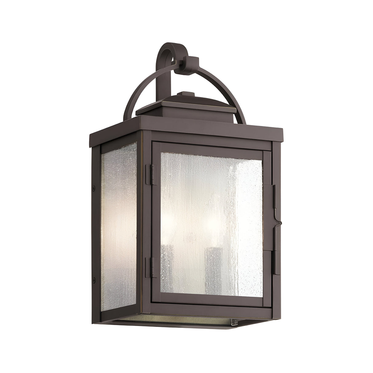 The Carlson Outdoor 2 Light Wall Lantern in rubbed bronze showcases a rectangular frame with clear seeded glass panels. This modern design includes a top handle for easy mounting and effectively emits light, making it ideal for exterior use.