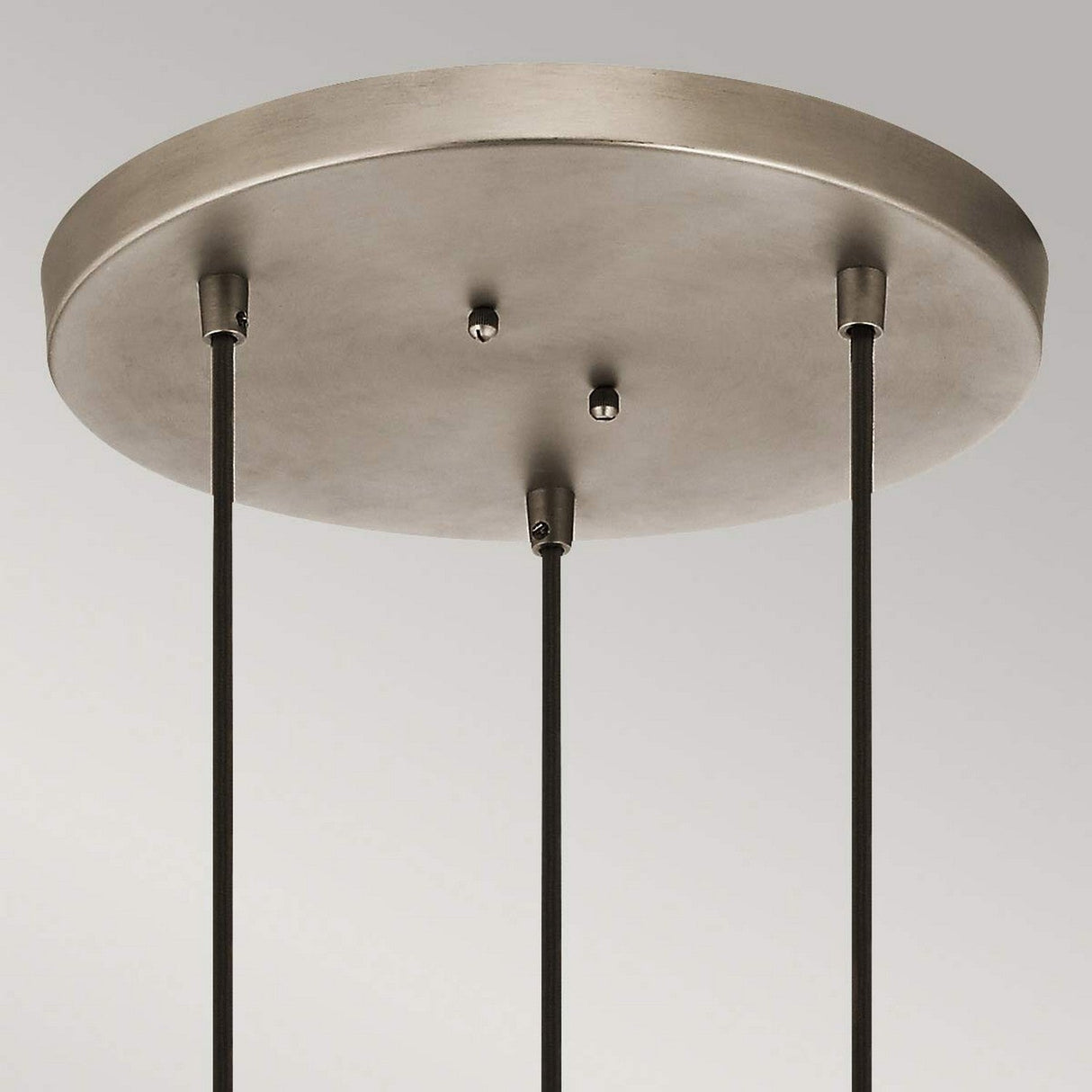 Ceiling fixture featuring the Ceiling Pan Round Ceiling Plate in a silver finish, complemented by three dark rods extending downward. The minimalistic and modern design provides versatile lighting solutions against a light gray background.