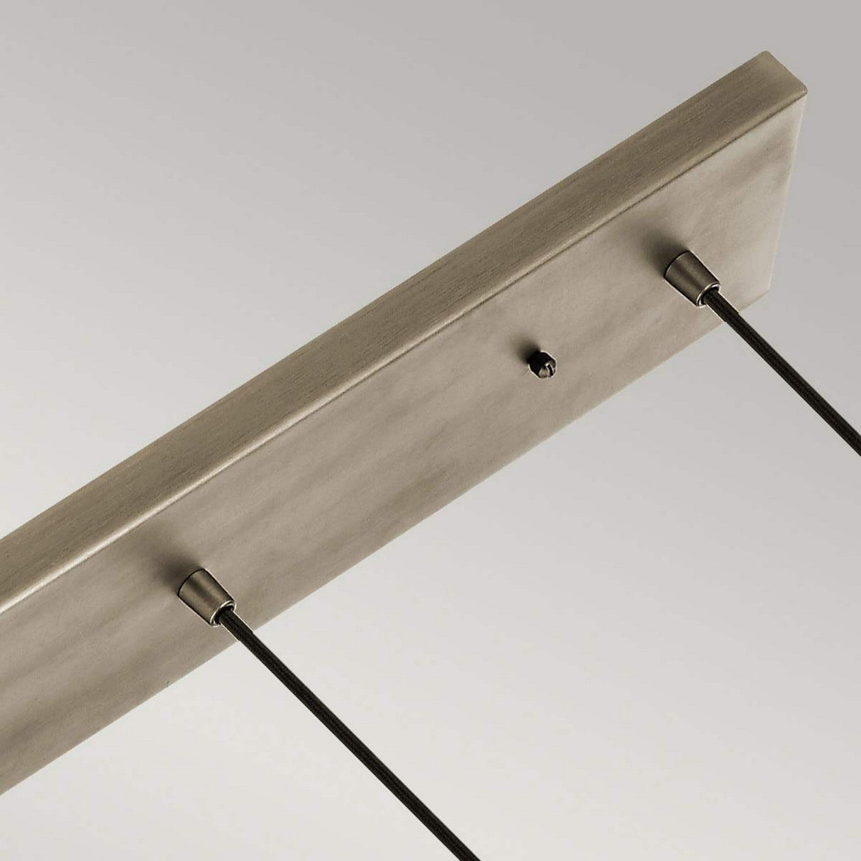 A close-up view showcases the Ceiling Pan Rectangular Ceiling Plate in silver, featuring two attached cables. The minimalist design exudes a sleek, neutral tone against a plain gray background.