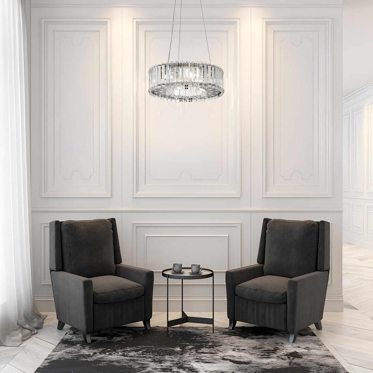 In a luxurious seating area, two black armchairs face each other with a small round table in between, embellished by the Crystal Skye 6 Light Chandelier - Chrome. Two cups rest on the table, accentuated by LED-compatible lighting as light filters through sheer curtains against elegant paneling.
