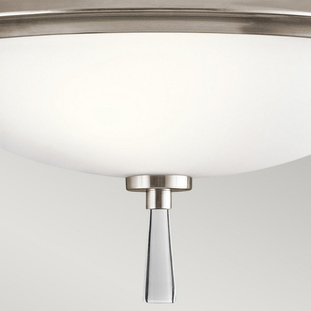 A close-up of the Dreyfus 3 Light Semi Flush - Silver showcases its frosted glass dome with a sleek metallic accent, highlighted by an optical crystal ornament hanging at the center for a touch of modern elegance. The softly lit background amplifies its sophisticated charm.