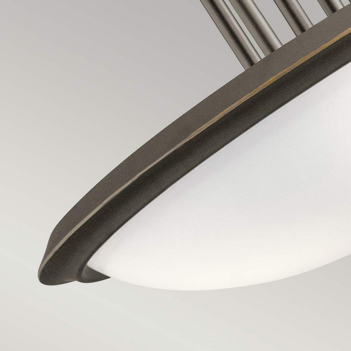 Close-up of the Dreyfus 3 Light Semi Flush with its modern circular design. The fixture features an Olde Bronze frame surrounding a frosted white glass dome, set against a neutral backdrop. The image accentuates the elegant curves and minimalistic style, enhanced by an optical crystal detail.