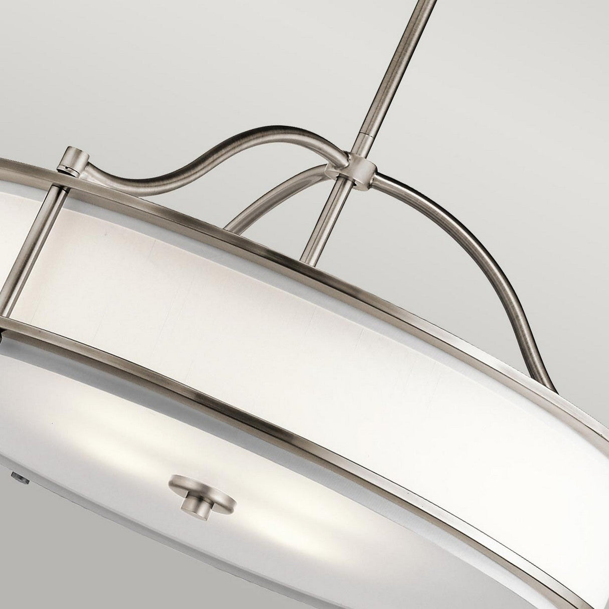 Close-up of the Emory 4 Light Duo-Mount Chandelier - Silver, showcasing its modern semi-flush ceiling light fixture design with a circular silver metal frame and frosted glass shade. The chandelier-like appearance includes sleek, curved metal rods that connect the frame elegantly to the ceiling.