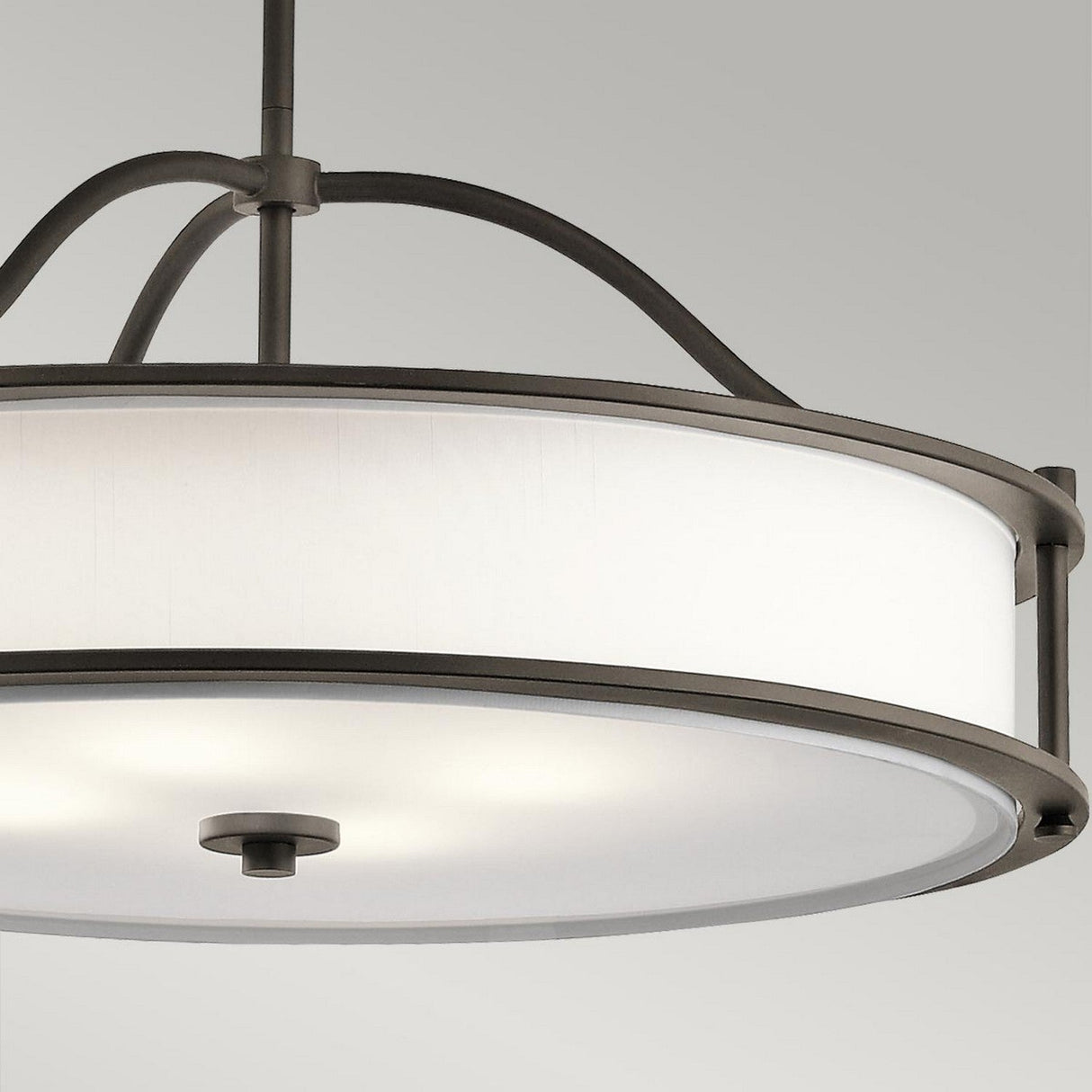 The Emory 4 Light Duo-Mount Chandelier, with its Olde Bronze finish, is a modern round ceiling fixture that features a white fabric drum shade and metal frame. Its simple and elegant design makes it an ideal choice for contemporary interiors.