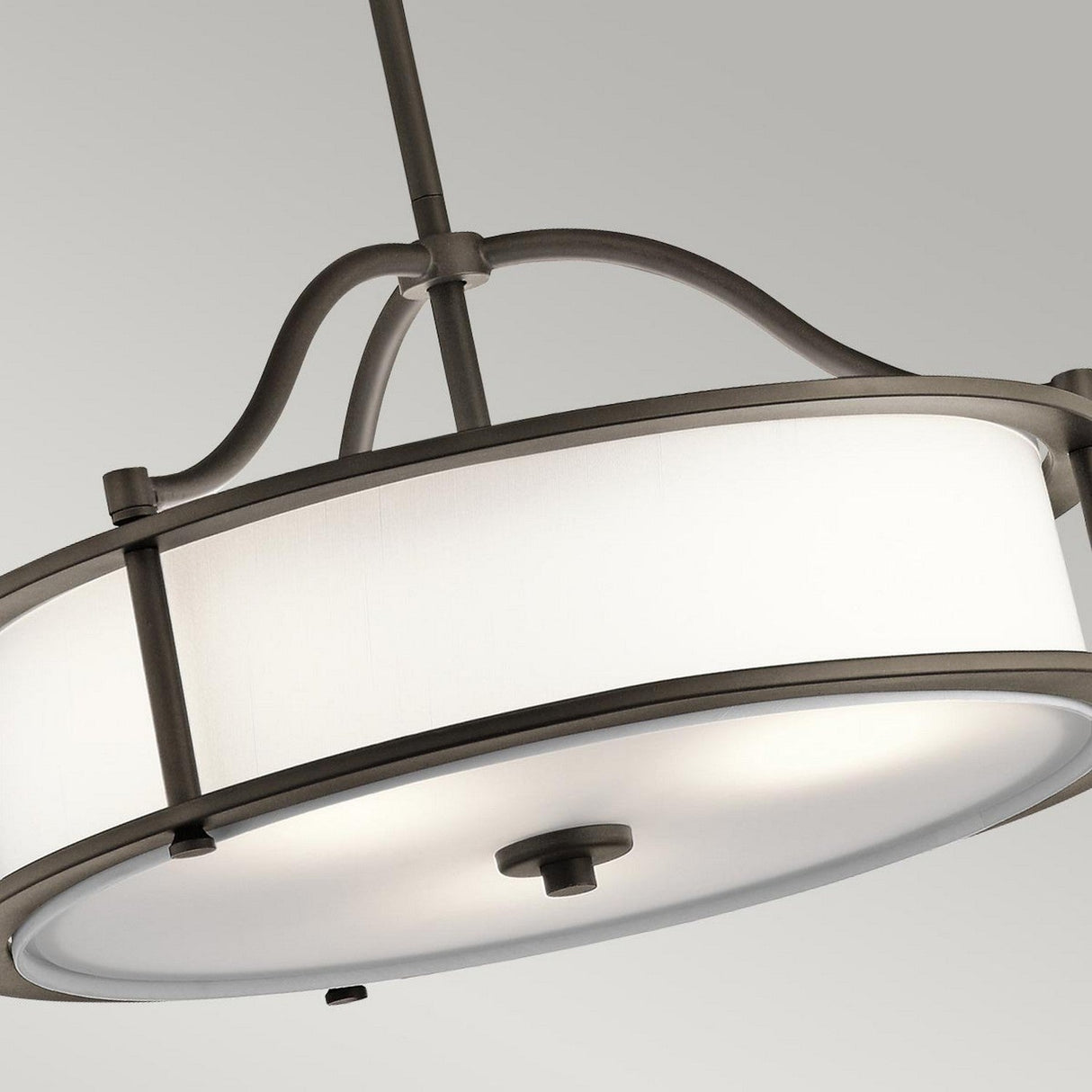 The Emory 3 Light Duo-Mount Pendant/Semi-Flush – Olde Bronze showcases a modern design with its round fabric drum shade and metal frame. This contemporary lighting piece, finished in Olde Bronze, is elegantly suspended from a rod on a neutral-colored ceiling, adding sleek sophistication to any room.