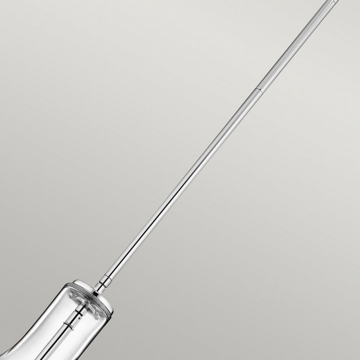 Close-up of the Everly 1 Light Small Pendant - Chrome, featuring a sleek and modern design against a neutral gray background. The chrome finish adds an elegant touch, with part of the pendant's structure partially visible.