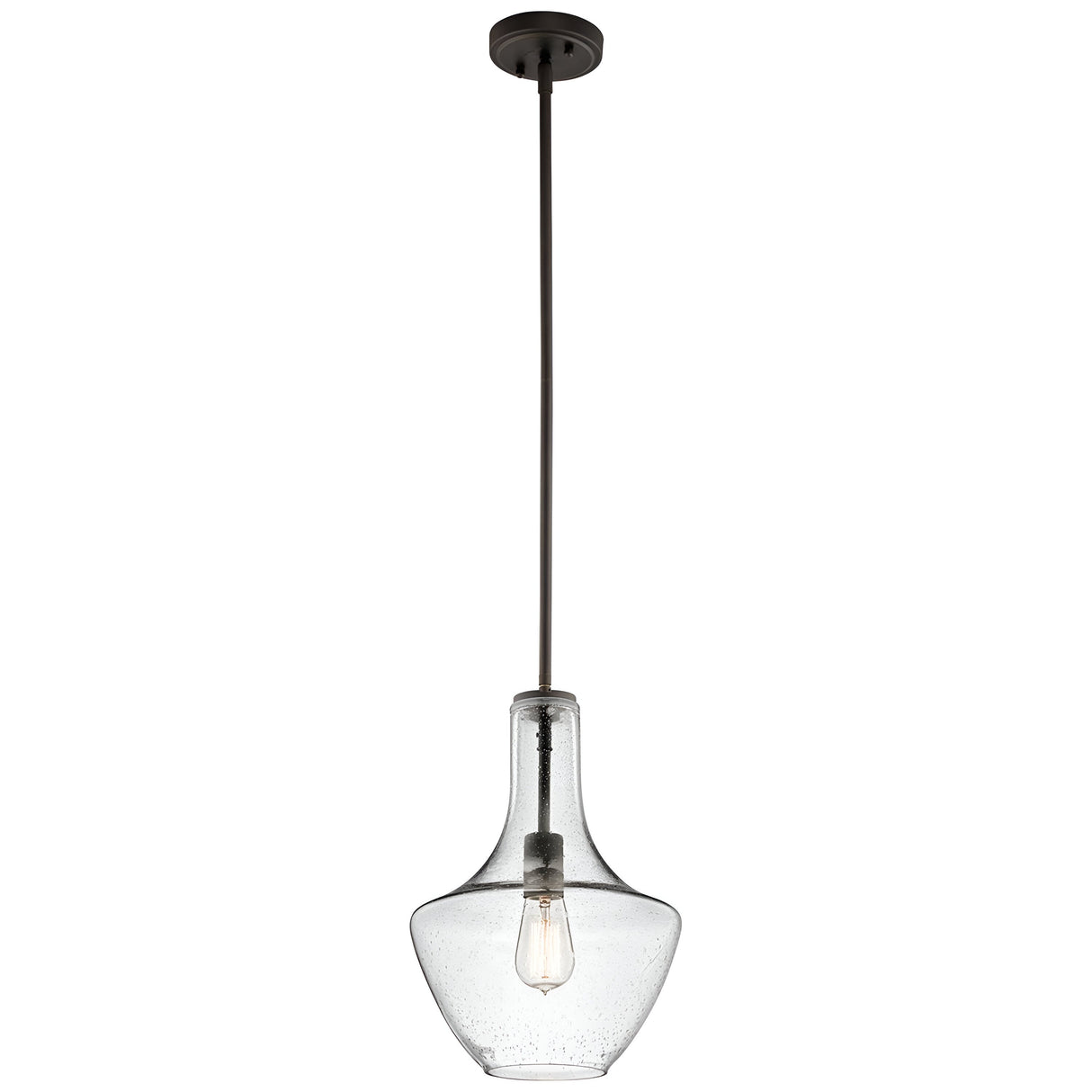 The Everly 1 Light Small Pendant in Olde Bronze boasts a sleek and minimalist design featuring a bell-shaped, clear seeded glass shade and an exposed vintage-style LED filament bulb hanging from a black rod.