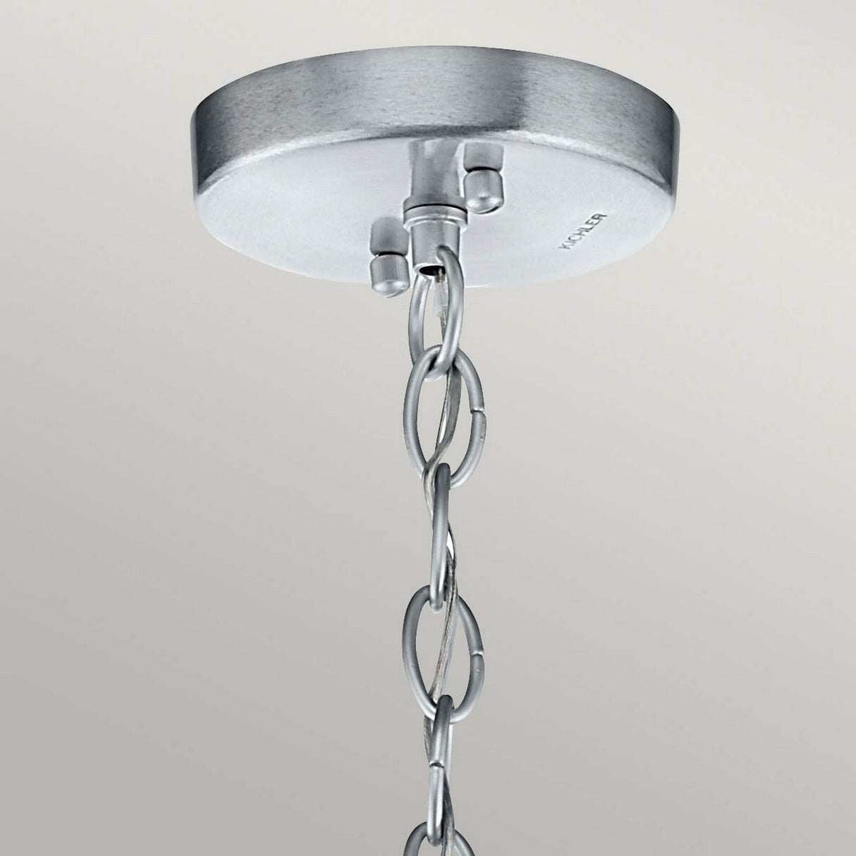A close-up view of the Grand Bank Outdoor 1 Light Pendant, showcasing its weather-resistant metal ceiling mount with a short chain, finished in antique grey and brushed aluminium against a neutral background.