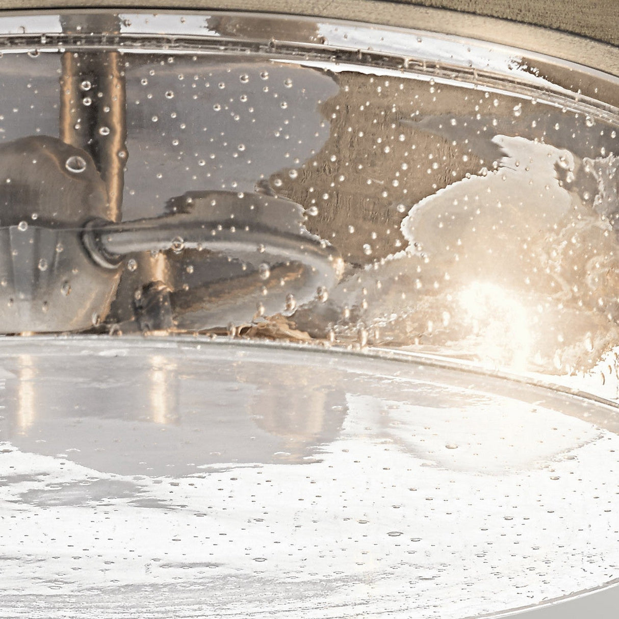 The Grand Bank 2 Light Semi Flush fixture embodies vintage industrial appeal with its round, transparent glass cover featuring water droplet detailing. Inside, the warm glow accentuates a metallic rod and silver hardware, all elegantly complemented by an antique grey finish for a truly timeless look.