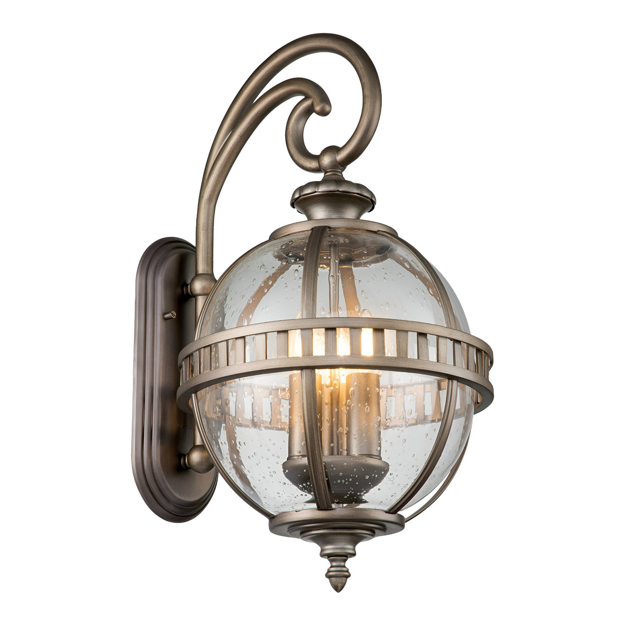 The Halleron Outdoor 3 Light Wall Lantern in burnished bronze showcases a vintage-style design with a clear glass globe and brushed metal frame. Featuring a decorative curved arm mount and visible bulbs, this piece brings Victorian elegance to any space, making it ideal for both outdoor lighting and indoor charm.