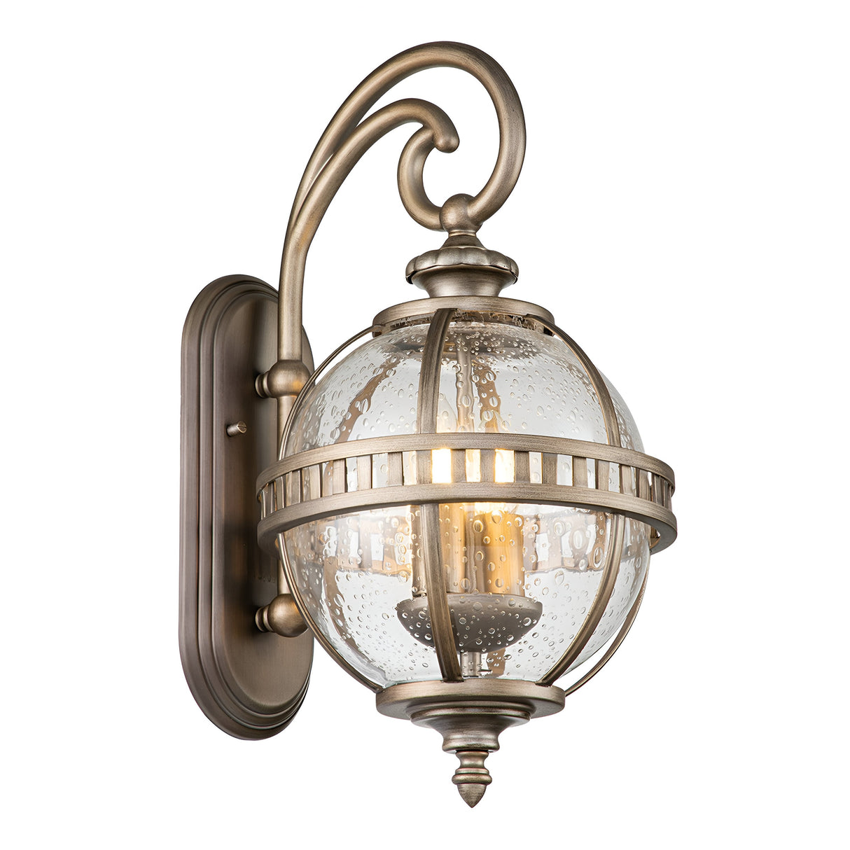 The Halleron Outdoor 2 Light Wall Lantern in Burnished Bronze showcases a vintage-style design with a decorative curved arm and a clear seeded glass globe surrounding the light bulb, seamlessly combining Victorian-era lighting elements for an elegant and traditional look.