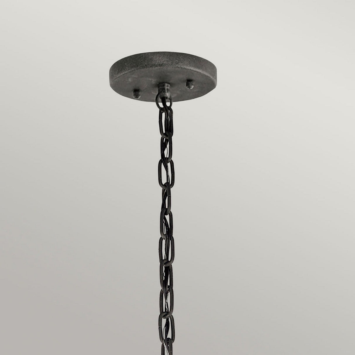 The Halleron Outdoor 3 Light Chain Lantern in grey, featuring a black metal chain, elegantly hangs from a circular ceiling mount set against a light gray background, evoking Victorian-inspired lighting.