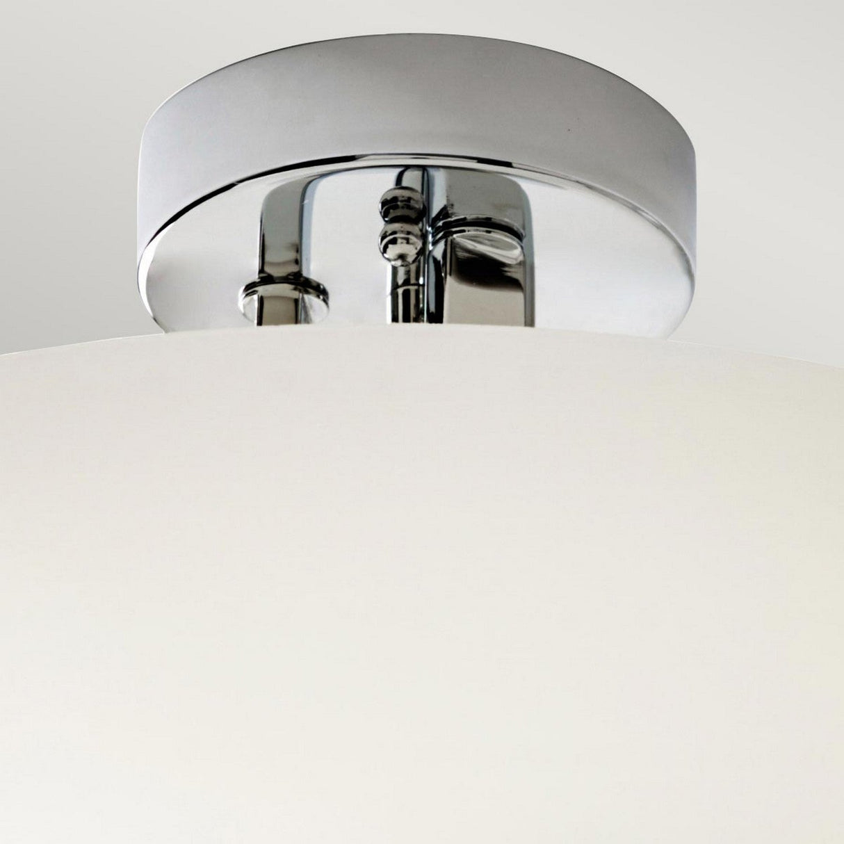 Detailed view of the Hendrik 3 Light Semi Flush in polished chrome, showcasing its modern aesthetic with a smooth, frosted glass shade. Ideal for bathroom lighting, this fixture boasts a sleek and contemporary design.