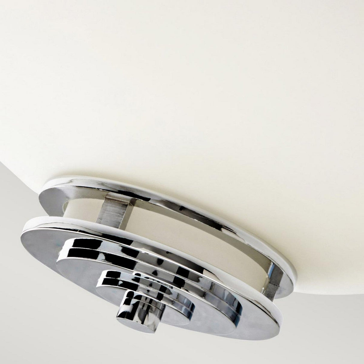 Close-up of the Hendrik 3 Light Semi Flush - Polished Chrome ceiling fixture with a sleek, polished chrome circular design. This bathroom lighting piece is mounted on a smooth, white background, highlighting its minimalist and contemporary style.