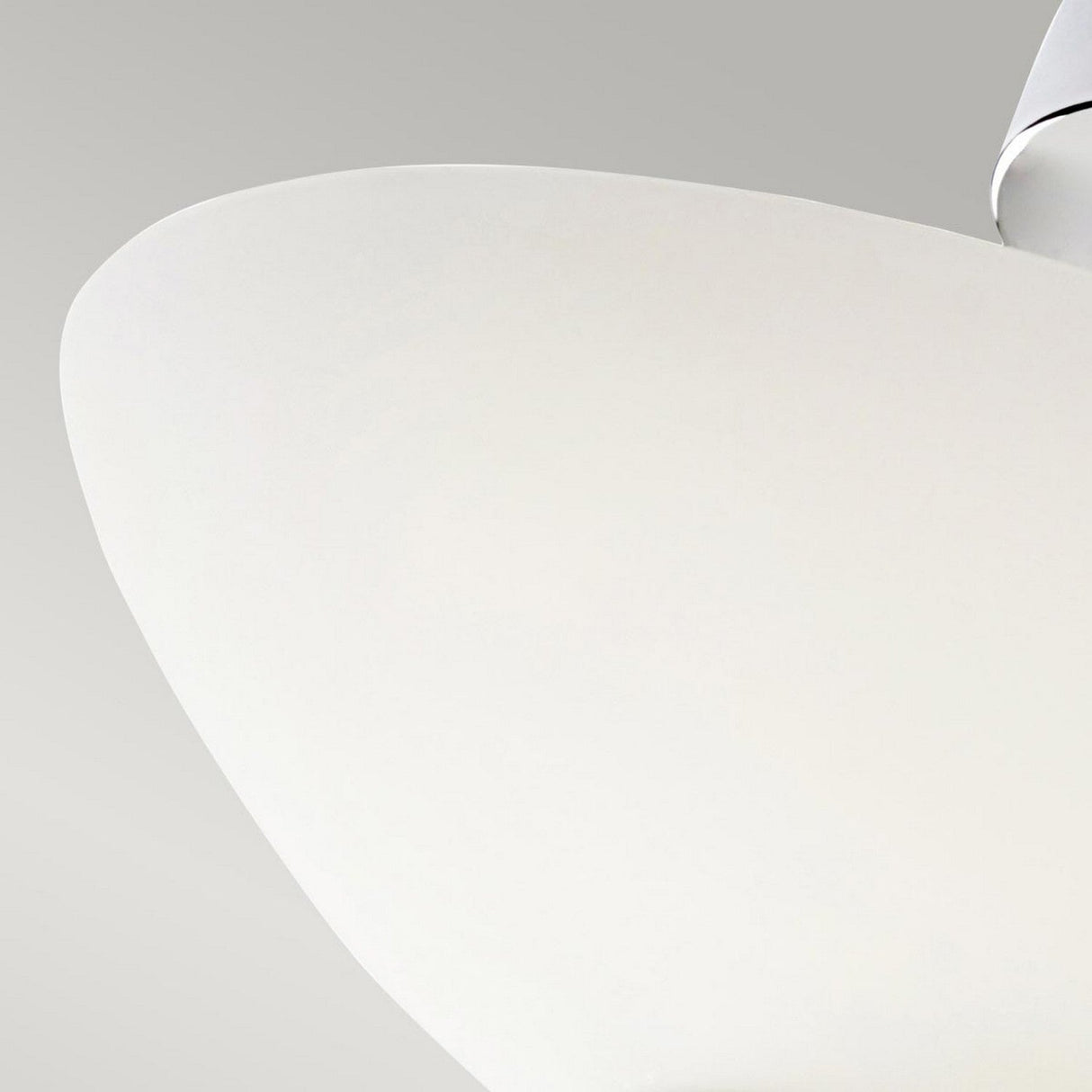 A close-up of a sleek, modern ceiling fan blade with a smooth white finish set against a light gray background. The image highlights the minimalist design akin to the Hendrik 3 Light Semi Flush - Polished Chrome fixture, showcasing clean lines that beautifully complement polished chrome bathroom lighting.