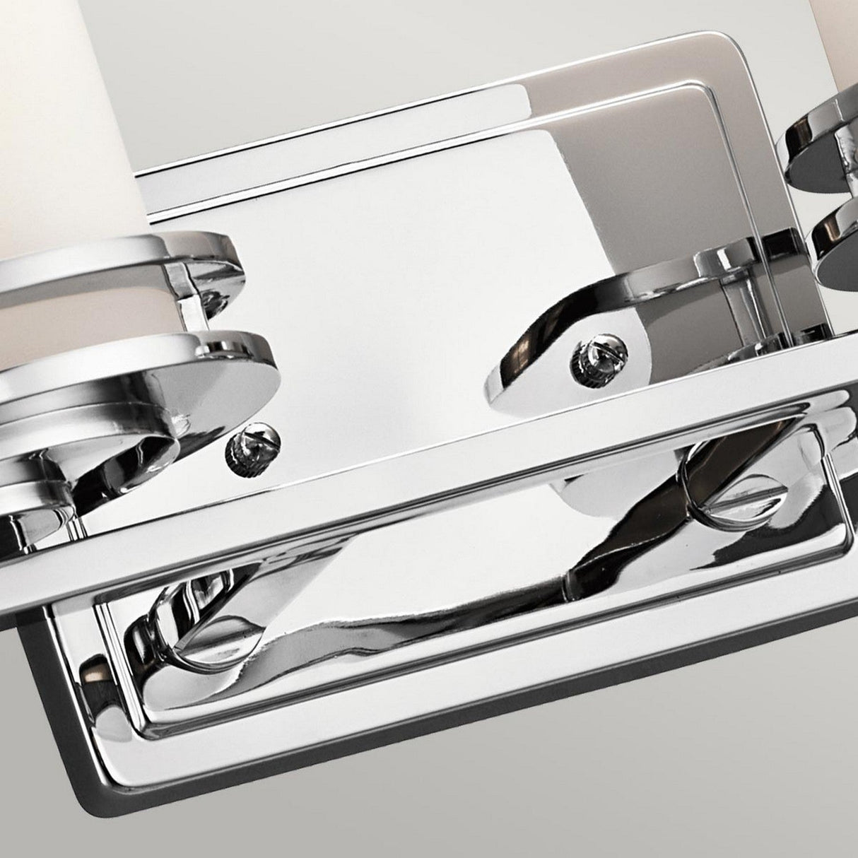 Close-up of a Hendrik 2 Light Wall Light in polished chrome, featuring sleek metal detailing and a reflective surface, ideal for enhancing bathroom lighting against a neutral background.