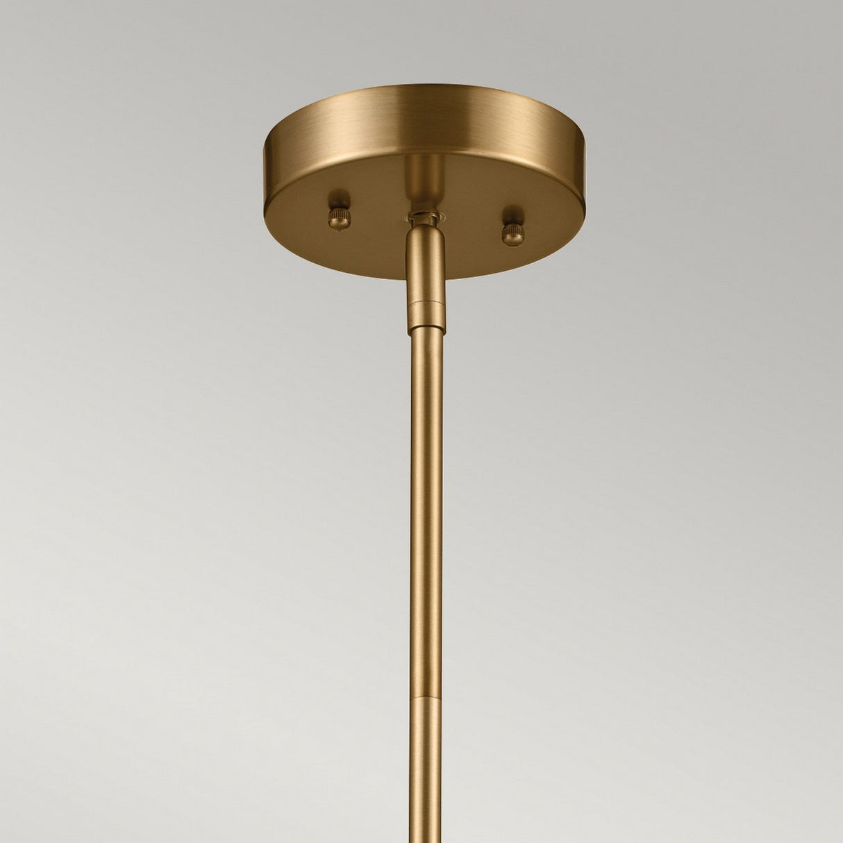 Close-up view of the Luella 3 Light Duo-Mount Chandelier/Semi-Flush in black and brass, showcasing a brass ceiling light fixture with a round base and cylindrical rod, elegantly mounted against a neutral background.