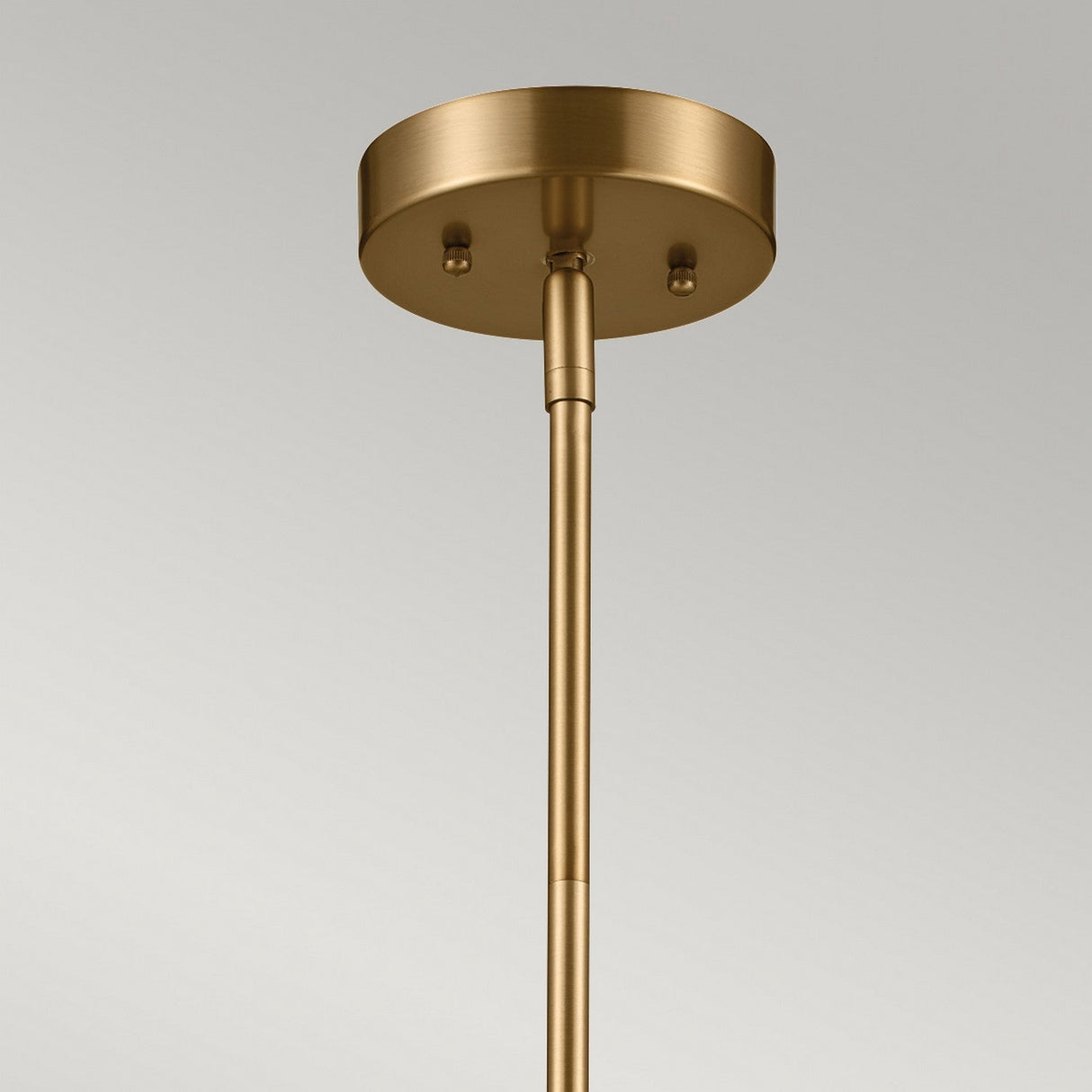Close-up of the Luella 3 Light Duo-Mount Chandelier/Semi-Flush in brushed natural brass, showcasing its sleek rod and round base against a neutral background.