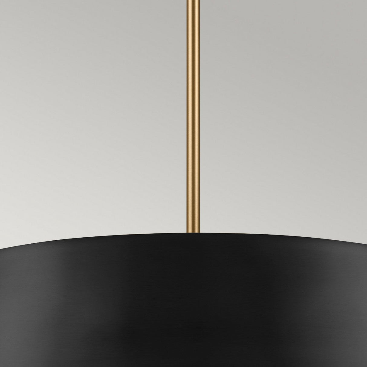 The Luella 4 Light Duo-Mount Chandelier/Semi-Flush - Black & Brass showcases a minimalist design with its sleek black lampshade and thin golden rod. This elegant fixture provides a striking contrast against a soft gray backdrop, adding an air of understated luxury.