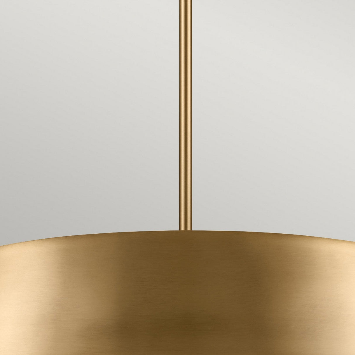 A close-up of the Luella 4 Light Duo-Mount Chandelier/Semi-Flush showcases its modern, smooth, and curved design crafted in brushed natural brass. This elegant fixture hangs from a matching rod against a neutral background, casting a soft, warm glow reminiscent of an exquisite chandelier.