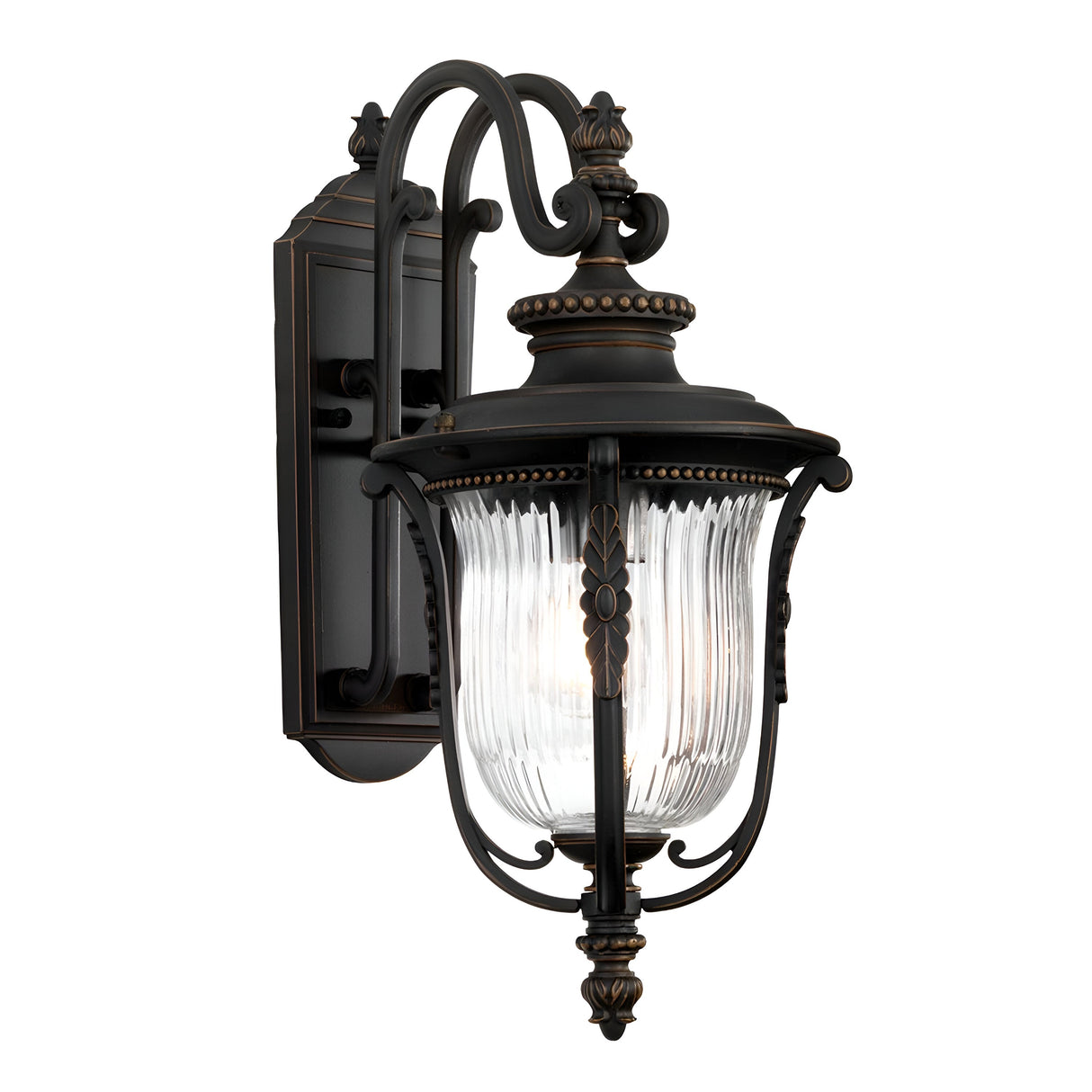 The Luverne Outdoor 1 Light Medium Wall Lantern in rubbed bronze showcases vintage-style charm with its ornate details and ribbed glass shade. It is elegantly suspended from a decorative curved arm, adding timeless elegance to any exterior space.