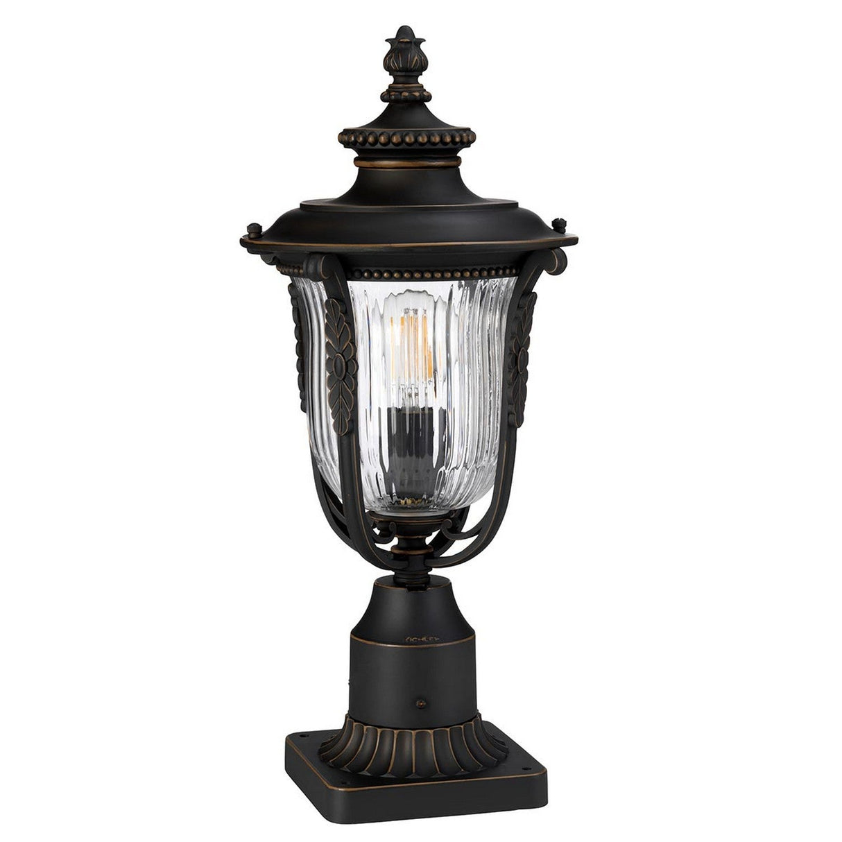 The Luverne Outdoor 1 Light Medium Pedestal in rubbed bronze showcases a vintage-style design with a metal frame and clear glass shade. Rated IP44 for weather resistance, this lantern includes decorative details and a square base, making it an elegant choice for enhancing outdoor lighting.