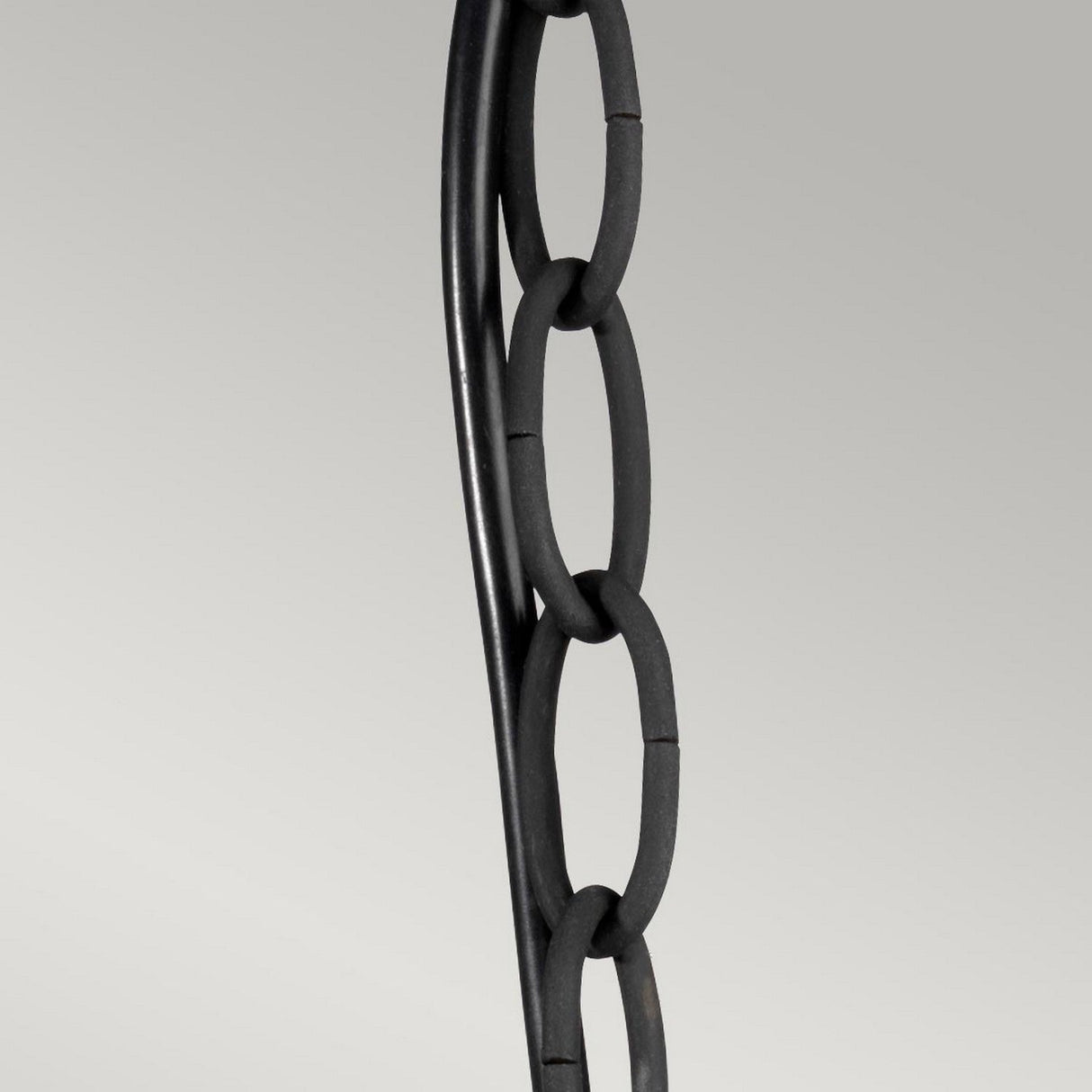 Close-up of the Luverne Outdoor 1 Light Medium Chain Pendant in rubbed bronze finish, showcasing its black metal chain composed of four vertically hanging oval links against a light gray background. The chain is slightly twisted, with evenly spaced links.