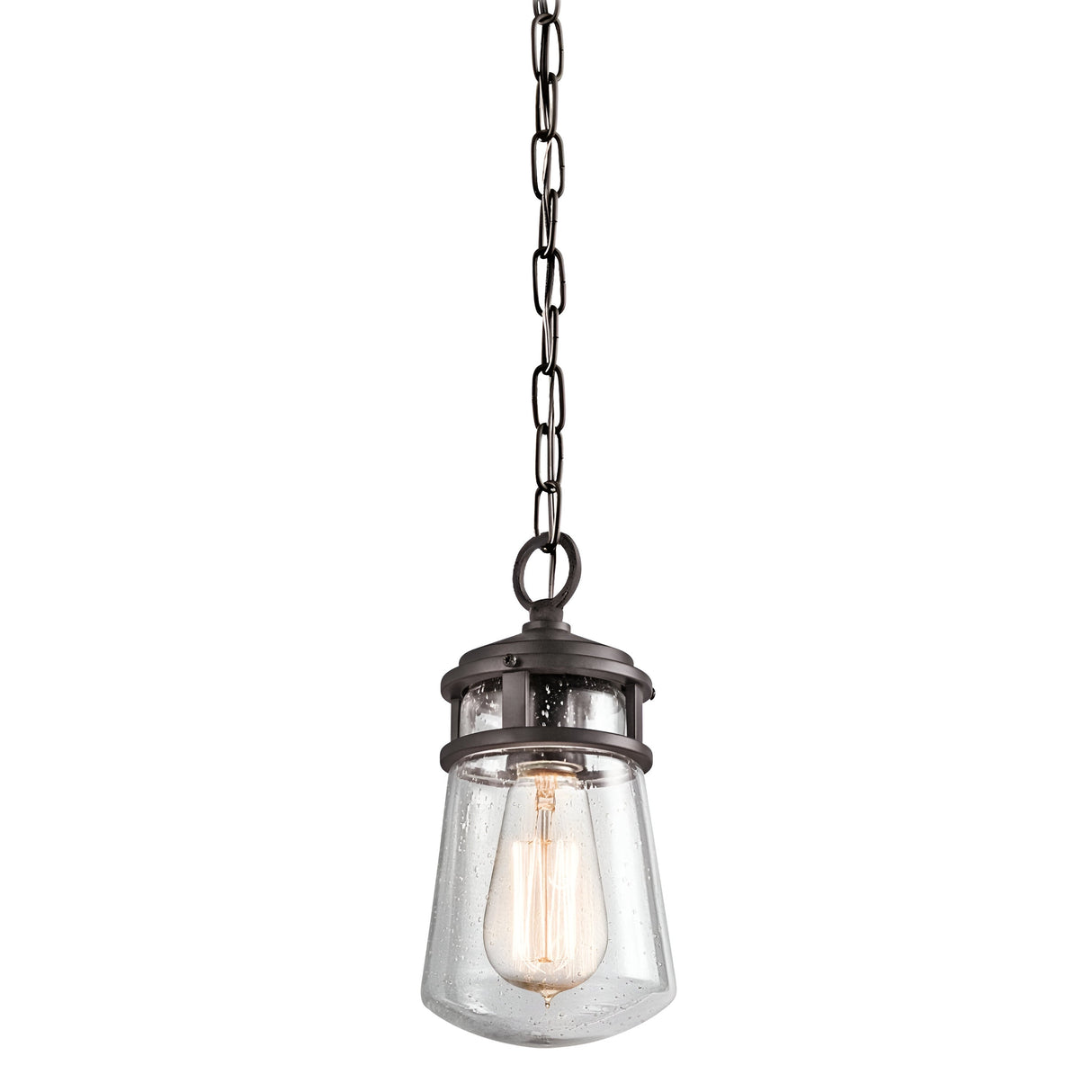 The Lyndon Outdoor 1 Light Small Chain Pendant in Bronze features a dark metal chain and fixture, complemented by a seedy glass shade. The exposed bulb casts a warm glow, enhancing its vintage-inspired design with an industrial touch.