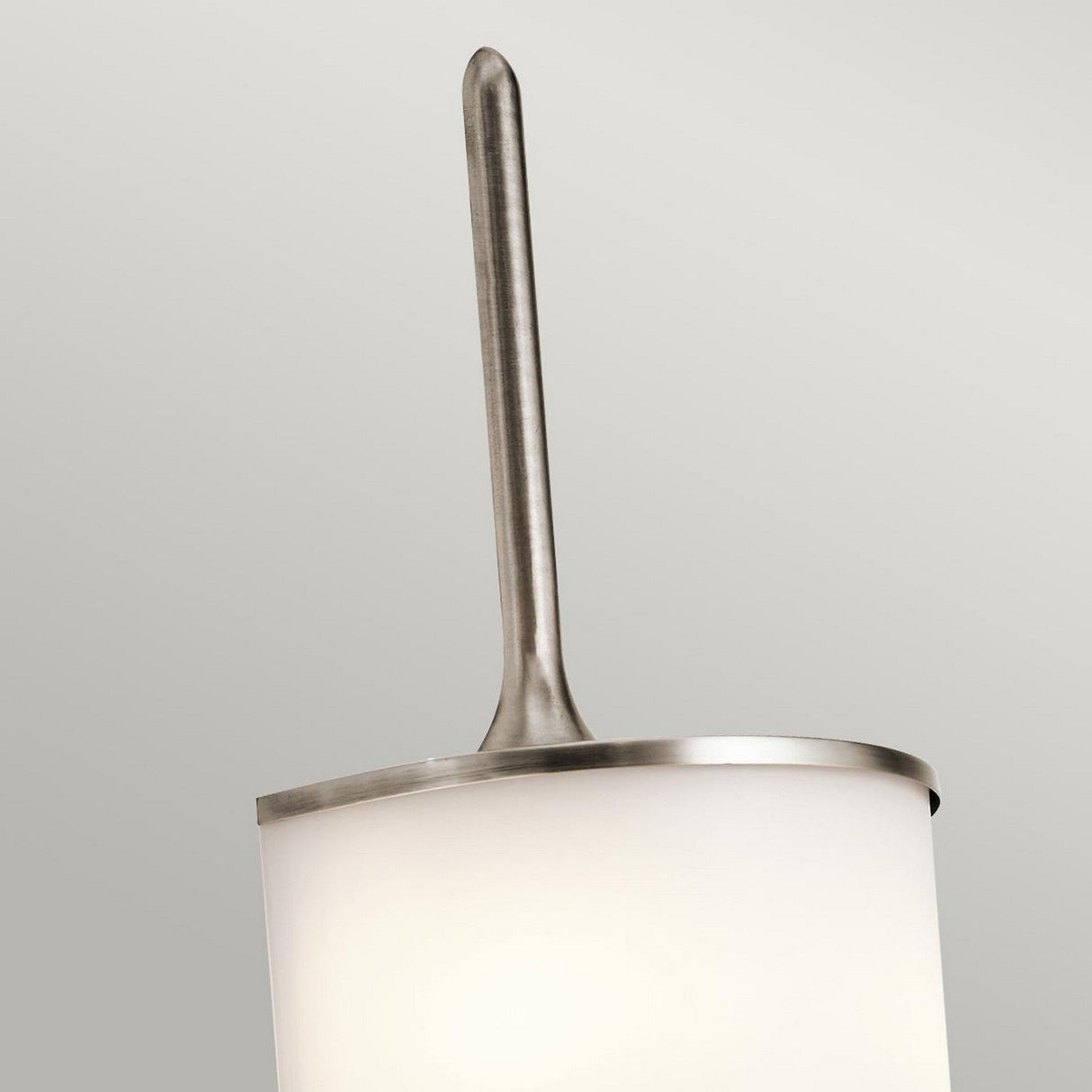 Introducing the Mona 2 Light Large Wall Light - Silver, a modern fixture that boasts a cylindrical white shade and a sleek metal rod with an elegant silver finish extending upward. Its minimalist, mid-century-inspired design complements any neutral background beautifully.