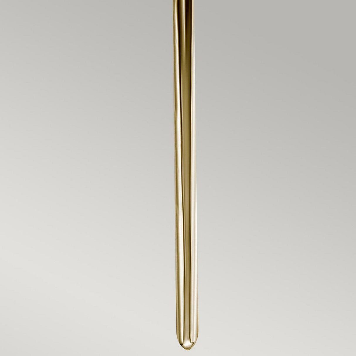 A long transparent glass tube, narrow and cylindrical in shape, hangs vertically against a neutral gray background, mirroring the Mid-Century Design of the Mona 2 Light Large Wall Light in Polished Brass. Its elegance is highlighted by understated touches of polished brass.