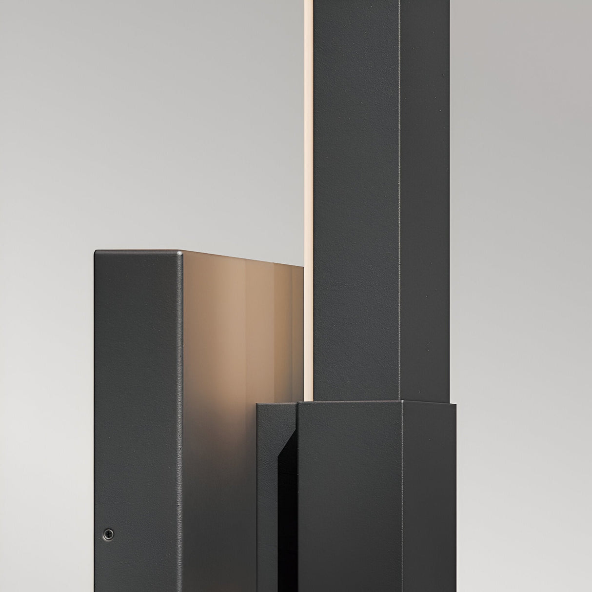 The Nocar LED Outdoor Large Wall Light 39W 3000K in black features a minimalist, geometric design with a warm glow from a narrow strip—ideal for modern exteriors and shown here against a plain grey background.