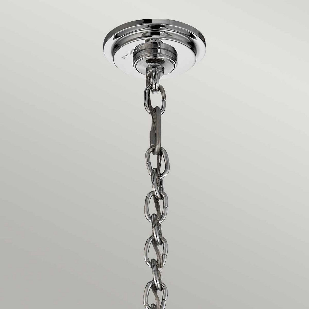 A polished chrome chain descends from the Piper 18 Light Chandelier, featuring glass bead accents, set against a light gray background.