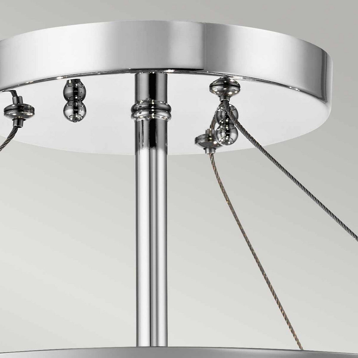 Close-up of the Piper 3 Light Semi Flush - Polished Chrome ceiling fixture, showcasing its circular base with three supporting cables. The design is sleek and enhanced with subtle glass bead accents, all set against a light gray background.