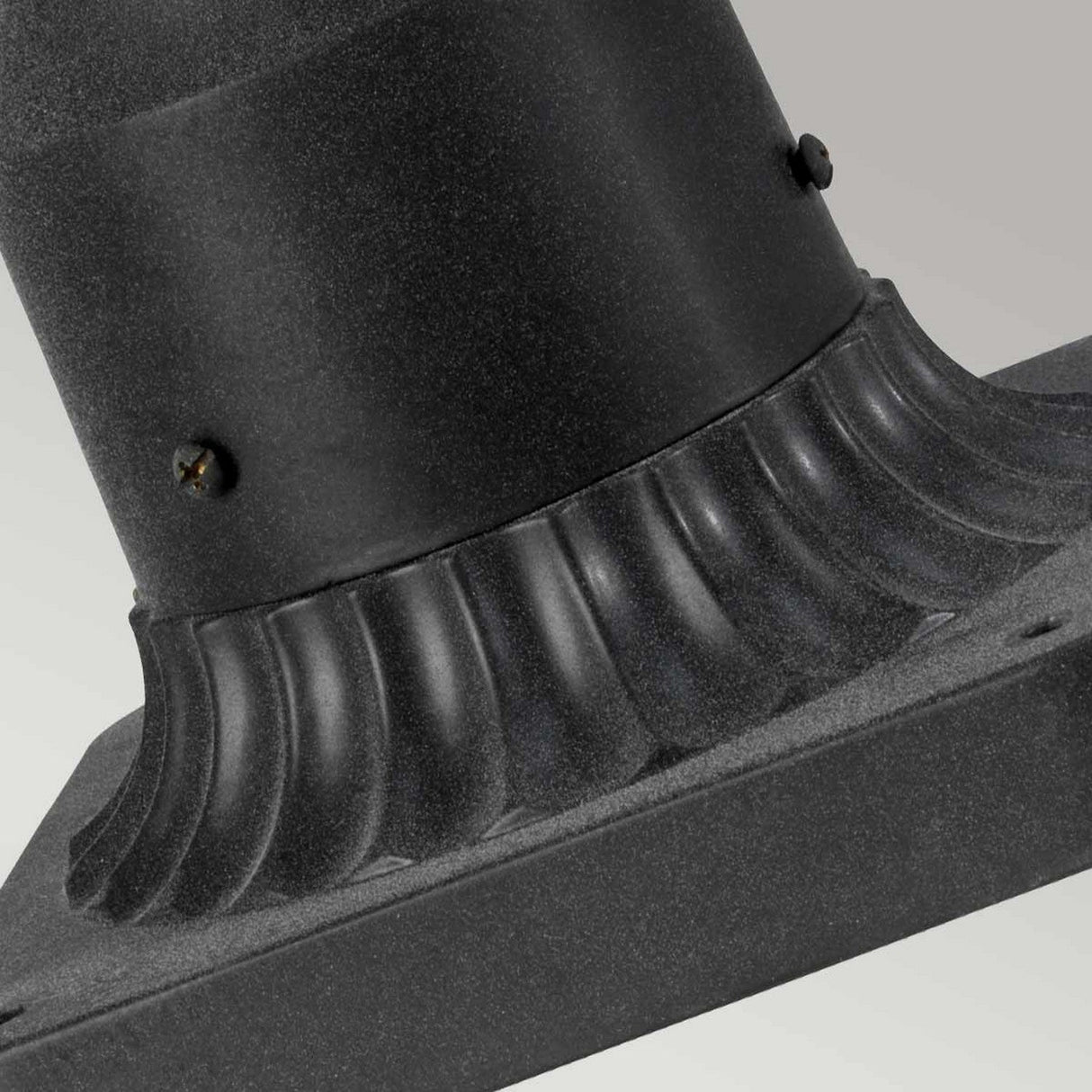 Product Name: Riverwood Outdoor 1 Light Pedestal Lantern - Weathered Zinc
A close-up of the Riverwood Outdoor 1 Light Pedestal Lantern showcases a textured black metal structure with a weathered zinc finish. It features a nautical-inspired design with a rounded base and vertical ribbing. Two screws can be seen fastening the top and bottom sections, all set against a gradient light gray background.