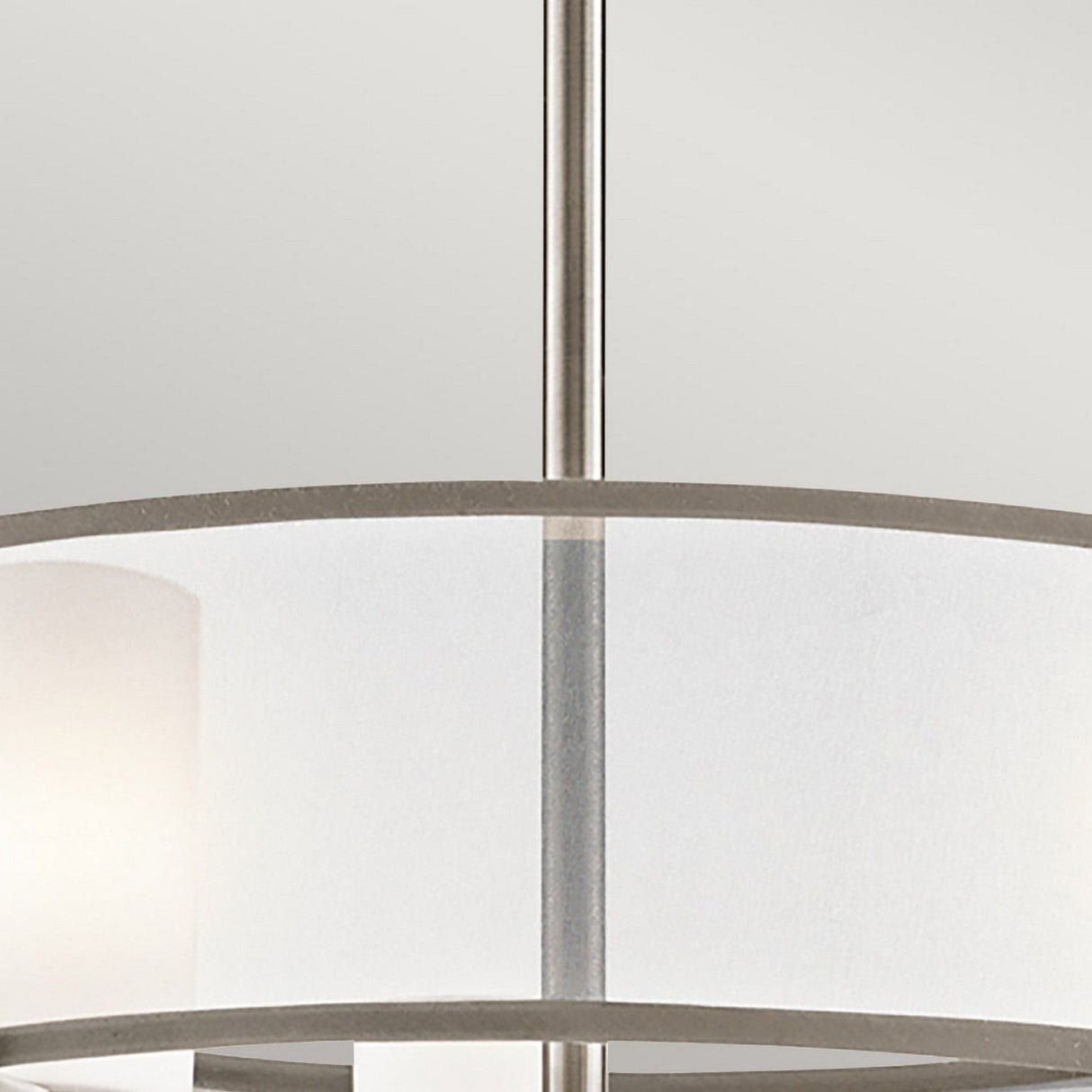 Close-up of the Saldana 5 Light Chandelier in silver, showcasing its modern design with a cylindrical white organza shade and brushed metal frame set against a neutral background.