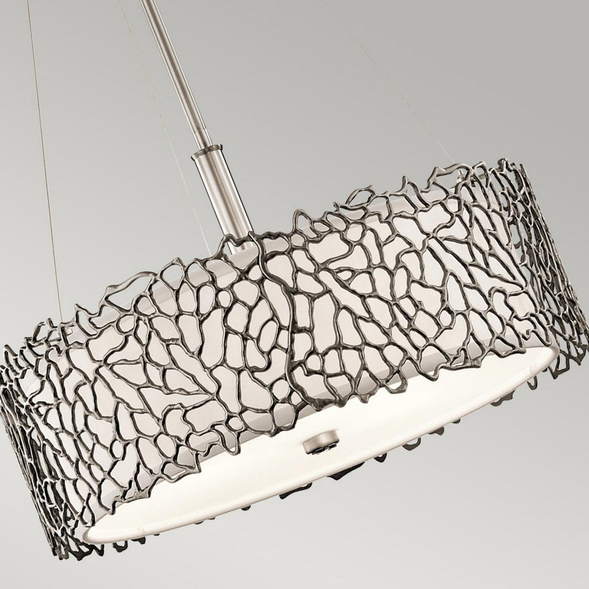 The Silver Coral 3 Light Pendant/Semi-Flush features a contemporary ceiling light with an elaborate open metal design encircling a round white shade, suspended from a metal rod. Its textured metalwork mimics organic, irregular patterns, adding an artistic flair to the minimalist style that echoes the design of a Silver Coral Pendant.