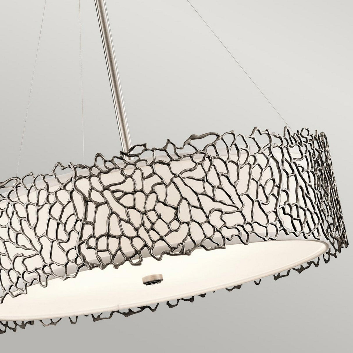 The Silver Coral 4 Light Drum Pendant - Silver showcases a contemporary design with its circular, coral-inspired structure and an intricately crafted metal exterior featuring abstract, interwoven patterns. It gracefully hangs from a polished metallic rod against a simple white backdrop.