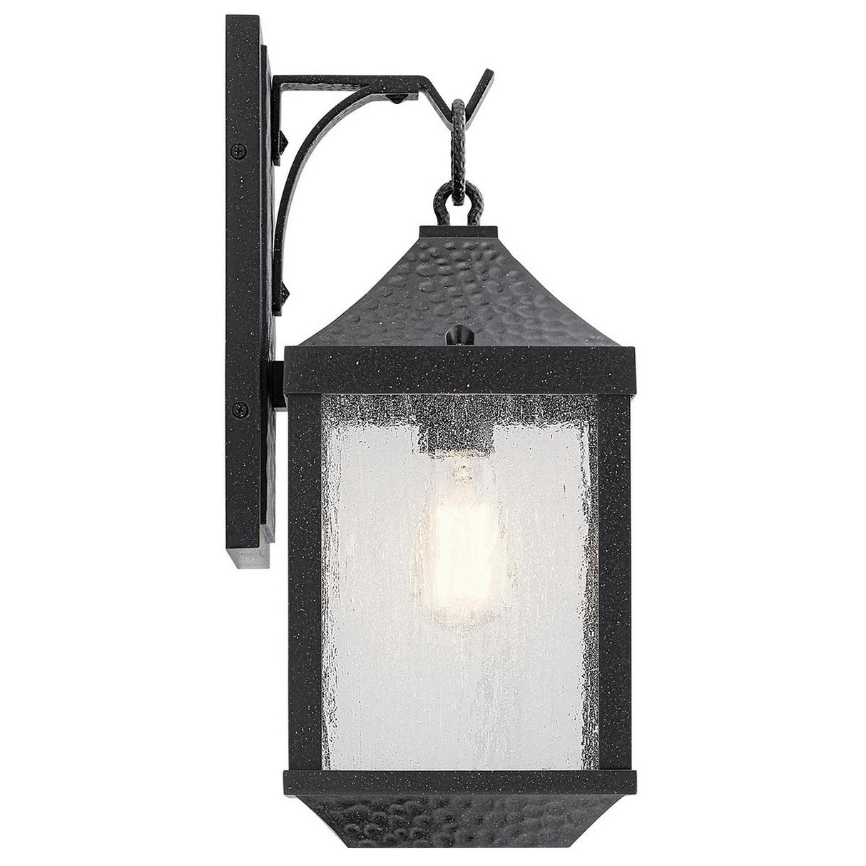 Springfield Outdoor 1 Light Medium Wall Lantern in Black, featuring distressed black finish and seeded glass panels. It boasts a classic design with a visible light bulb mounted on a rectangular backplate enhanced with decorative details.