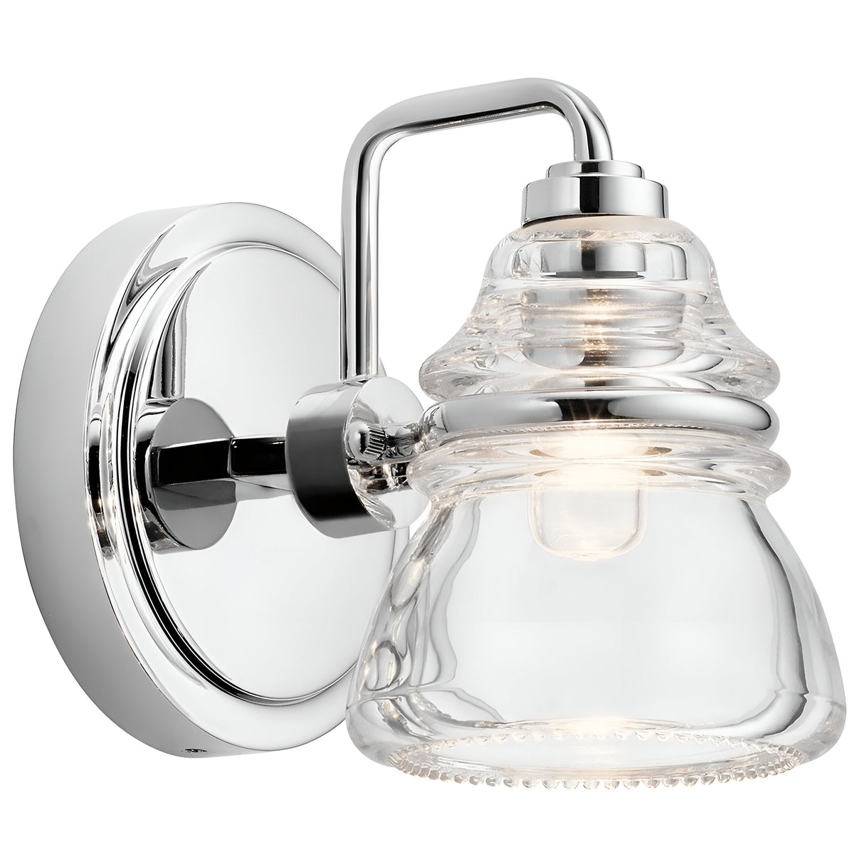 Presenting the Talland 1 Light Wall Light in Polished Chrome, featuring a bell-shaped clear glass shade. The round backplate combines contemporary and vintage styles, making it ideal for modern interiors that enjoy visible light bulbs and sleek design.
