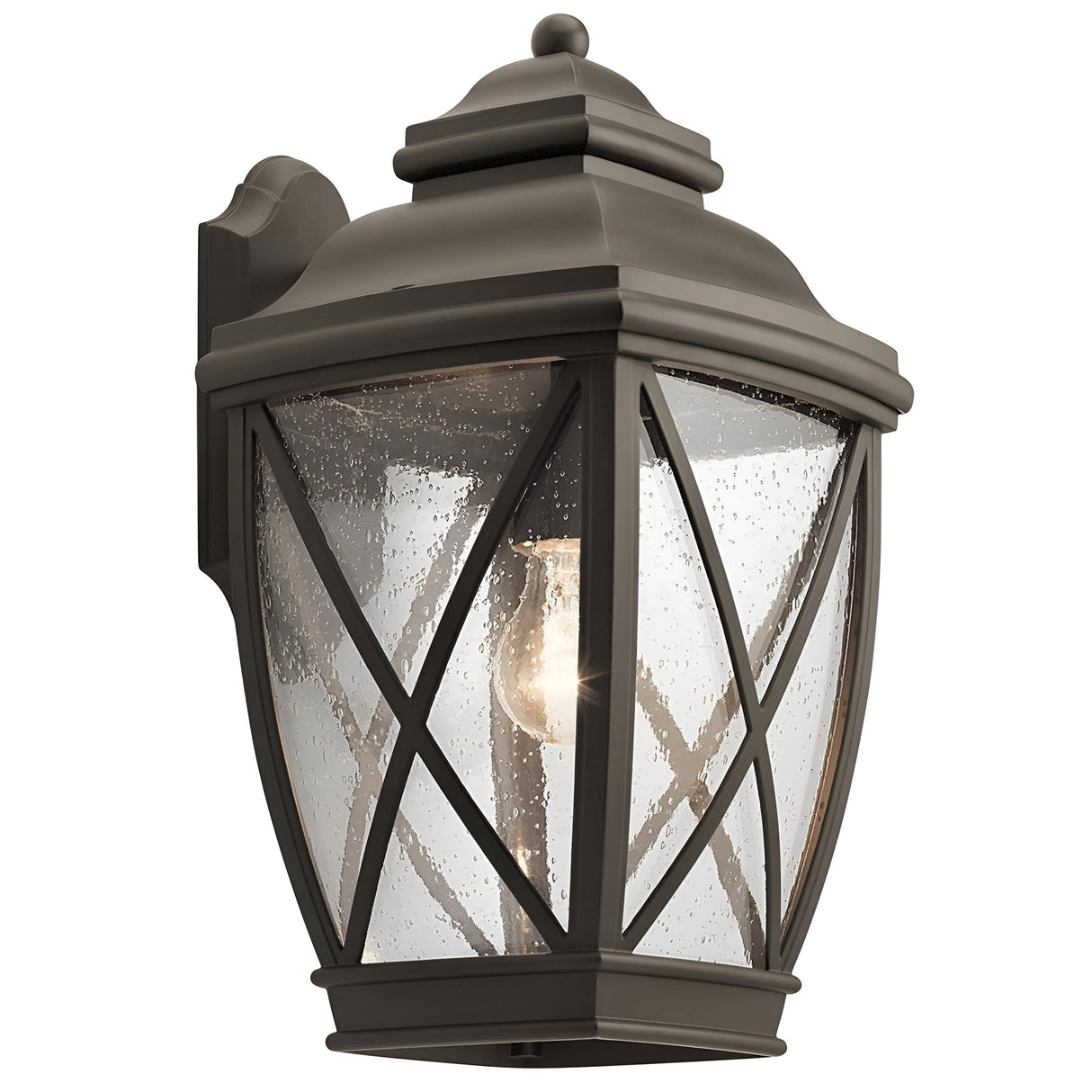 The Tangier Outdoor 1 Light Large Wall Lantern - Olde Bronze is a black outdoor wall lantern with a classic design featuring a visible bulb inside a clear glass enclosure. The dotted texture of the glass adds charm, and it is elegantly mounted on a decorative wall bracket.