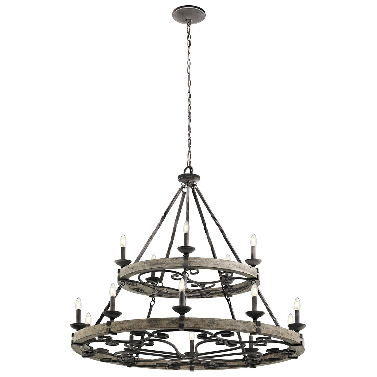 The Taulbee 15 Light Chandelier, featuring a weathered zinc finish, hangs from the ceiling with twelve candle-like lights beautifully displayed around two circular metal frames. These are linked by metal rods and chains, capturing an industrial and vintage aesthetic.