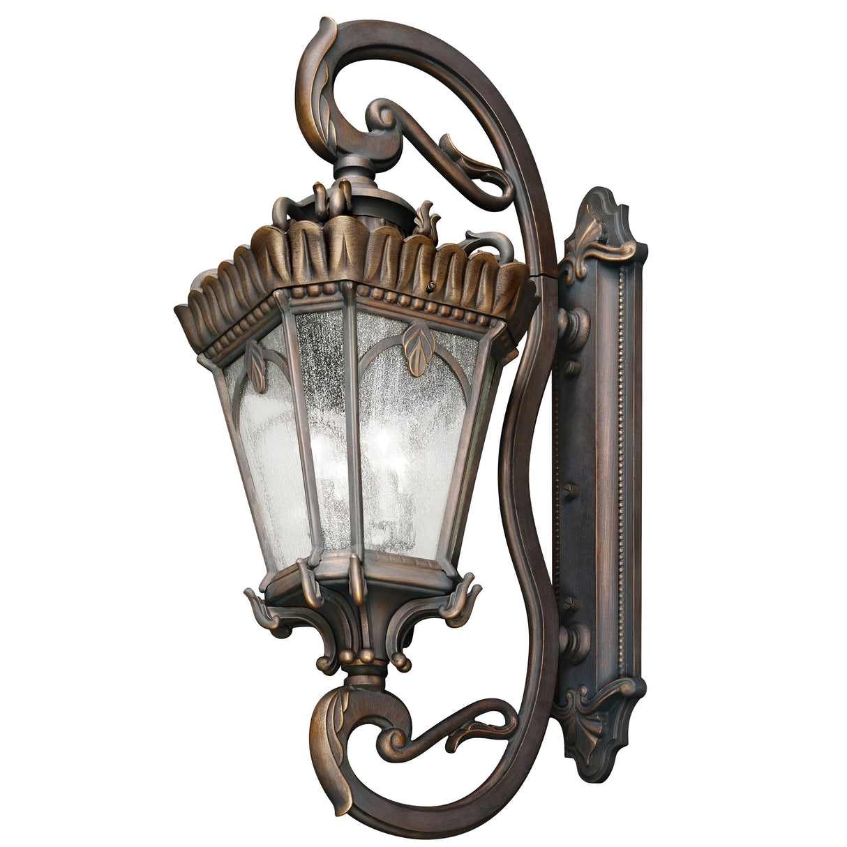 Introducing the Tournai Outdoor 4 Light Grand Extra Large Wall Lantern in bronze, featuring a vintage-style design with an ornate finish and a gracefully curved arm. This lantern is adorned with seedy glass panels and topped with a decorative leaf motif, bringing timeless charm to any outdoor setting.