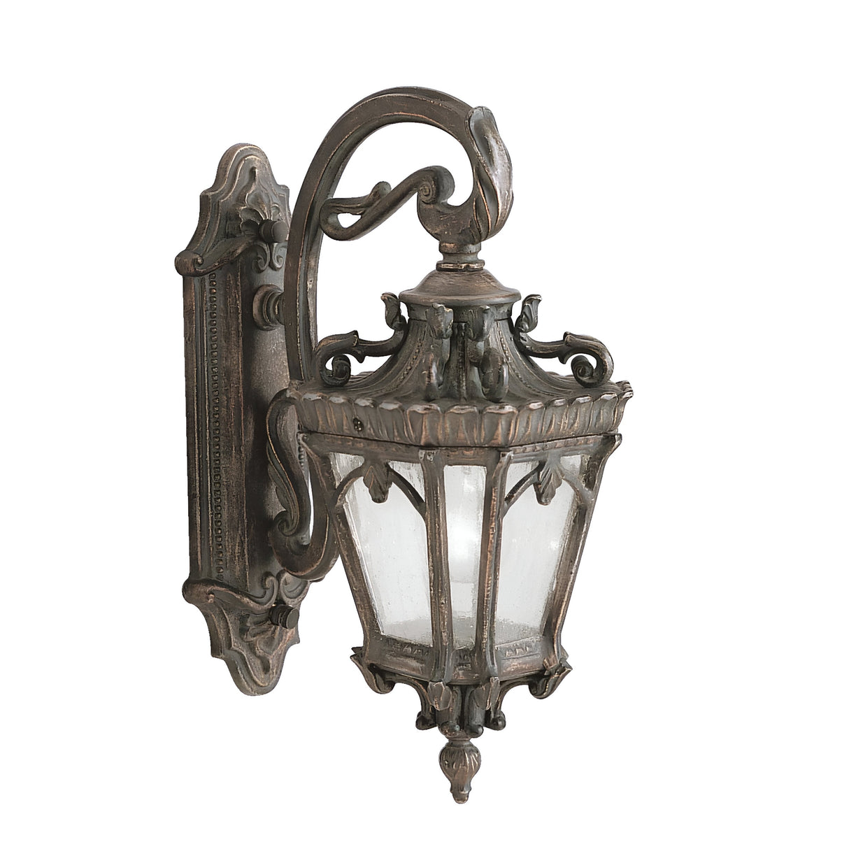 The Tournai Outdoor 1 Light Medium Wall Lantern in bronze adds elegance to your outdoor decor with its intricate metalwork, decorative arm, and seedy glass panels encased in a weathered frame.