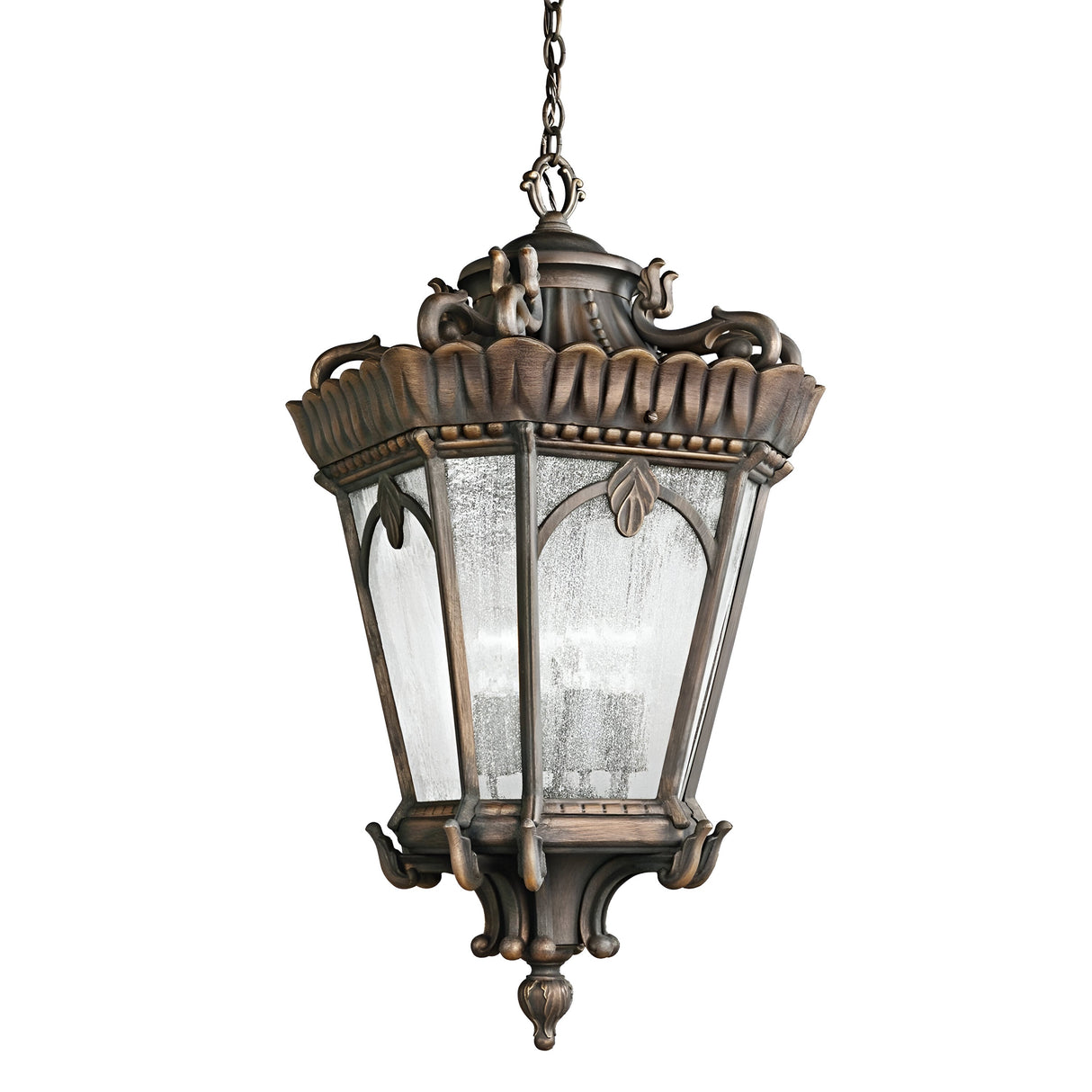 The Tournai Outdoor 1 Light Medium Chain Pendant - Bronze is a vintage-style lantern featuring ornate bronze detailing and frosted glass panels, elegantly suspended by a decorative chain.