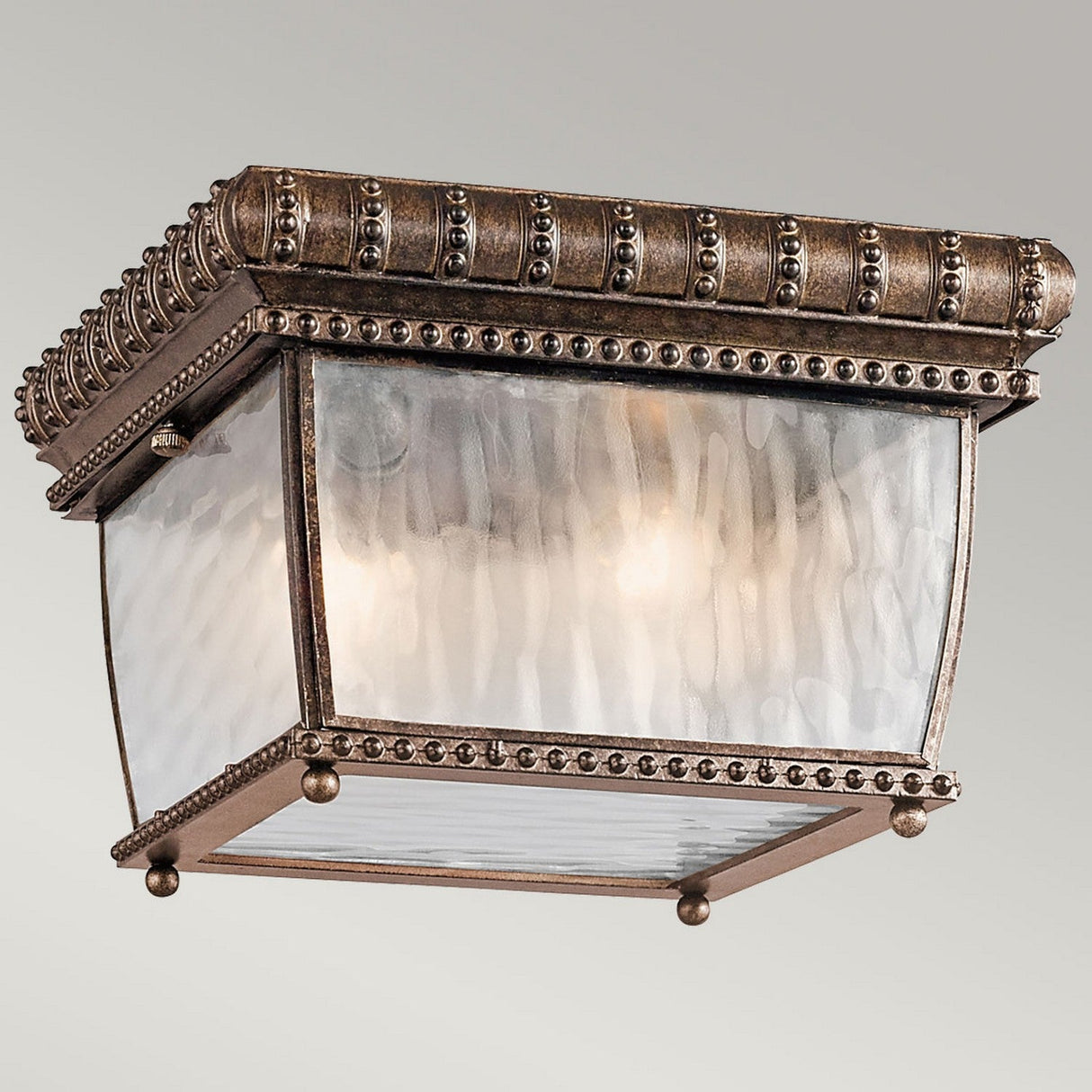 Introducing the Venetian Rain Outdoor 2 Light Flush in brushed bronze, featuring a vintage brass finish with intricate beaded detailing. Its textured glass panels and Renaissance-inspired design elements offer a timeless and sophisticated elegance to any space.
