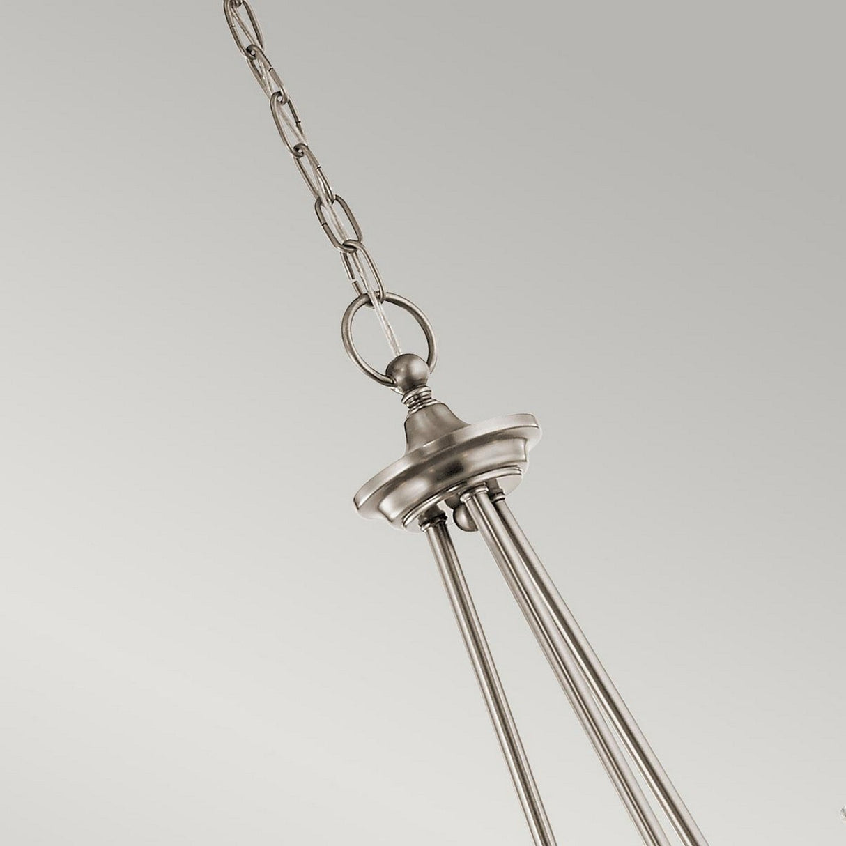 A close-up of the Waverly 5 Light Chandelier - Silver shows a sleek silver finish pendant light fixture, suspended from a chain against a plain gray background. The design includes vertical metal rods and a decorative ceiling mount, instilling elegance in any room.