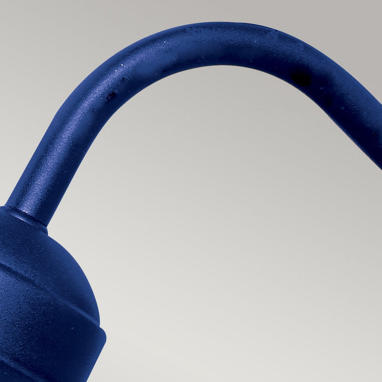 Close-up of the navy blue Klampenborg 1 Light Outdoor Wall Light, highlighting the sleek, curved design against a light gray background. The metallic texture and simple, Scandinavian-inspired aesthetic are emphasized.