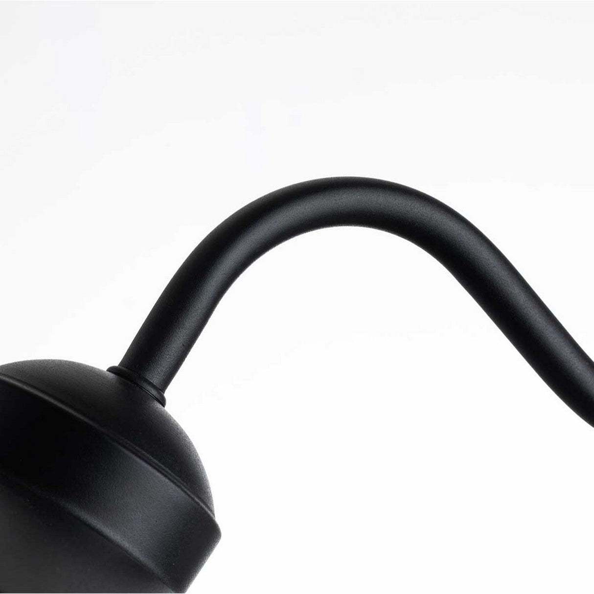 Close-up of the matte black arm of the Klampenborg 1 Light Outdoor Wall Light with PIR against a white background, showcasing its sleek and minimalist Scandinavian design.